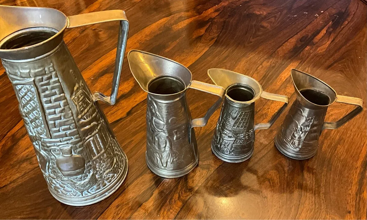 Set of 4 Antique Brass Embossed Pitchers - Image 1