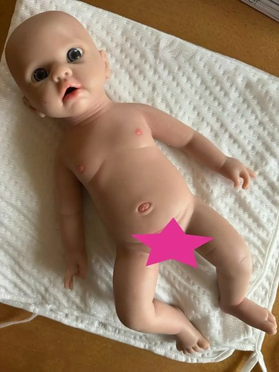 Full body silicone reborn baby doll in red outfit - Image 1