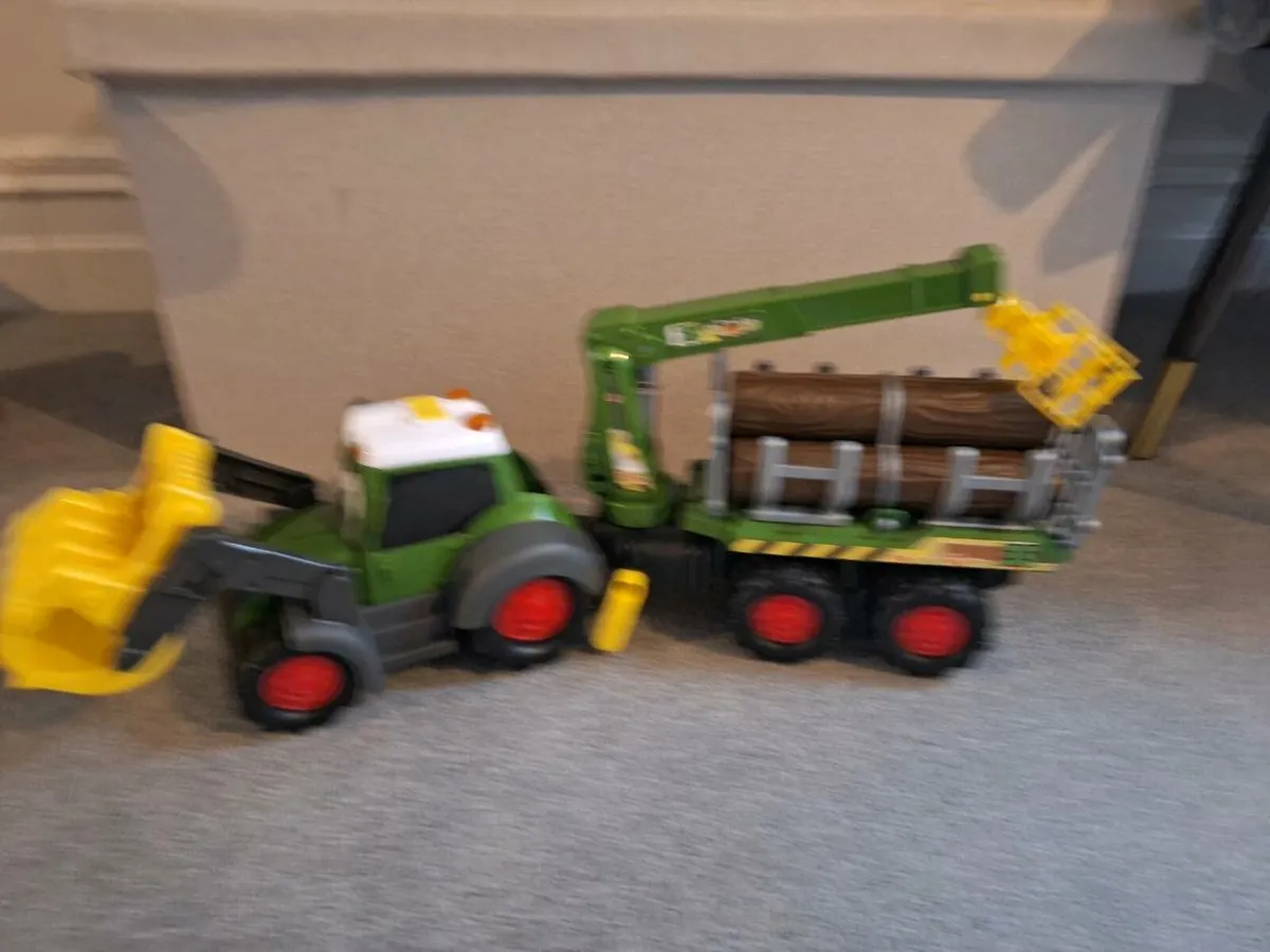 Tractor with logs in trailer