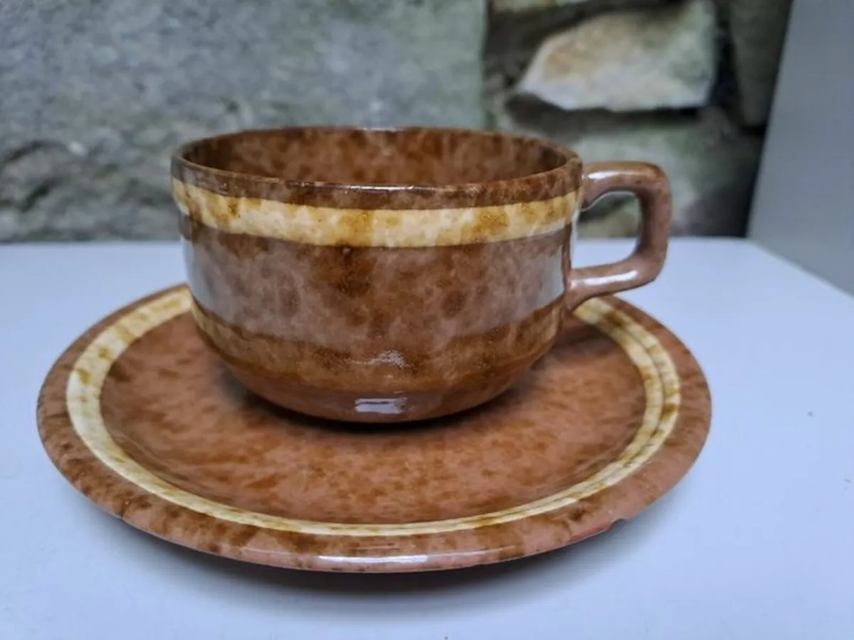 Brown and beige teacup and saucer - Image 1
