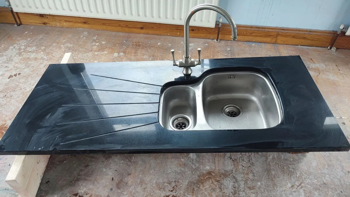 Granite countertop with sink and taps