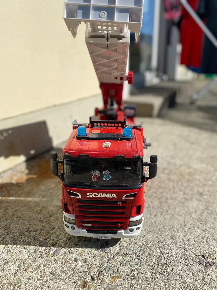 BRUDER Scania Super 560R Fire Service Ladder Truck - Image 1