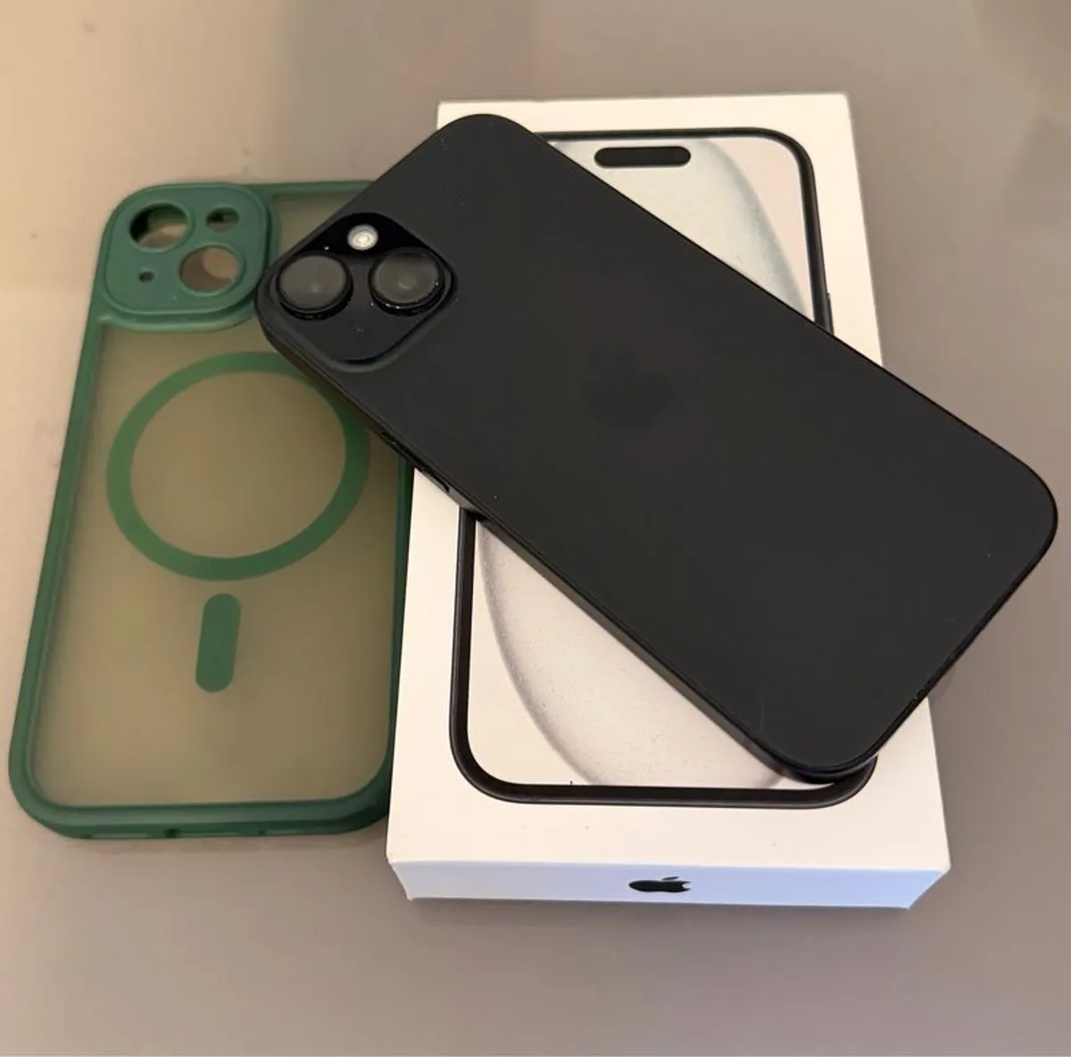 iPhone 15 with case and new official cable - Image 1