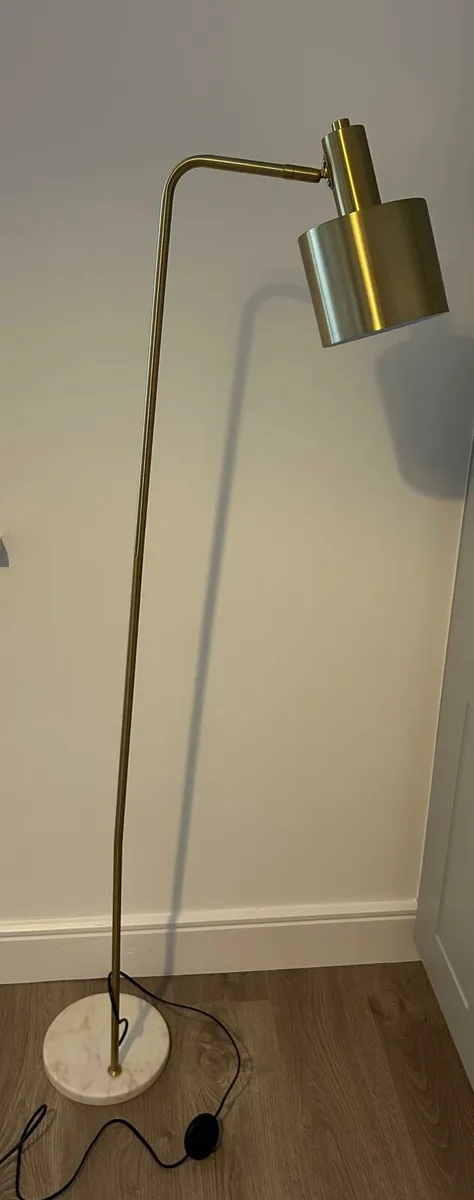 Two gold floor lamps