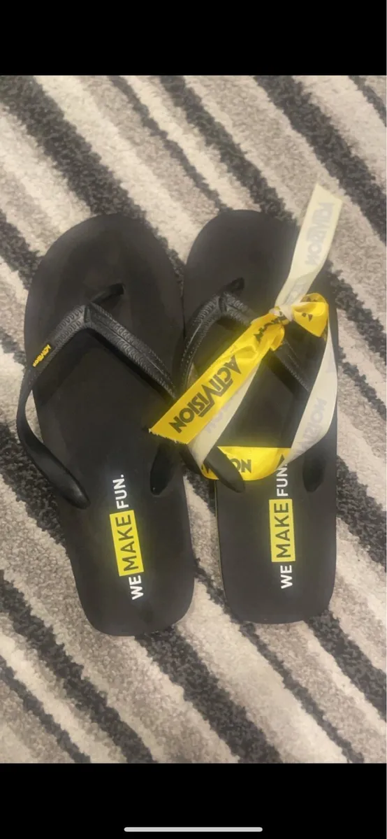 Black “WE MAKE FUN” Flip Flops – Activision - Image 1