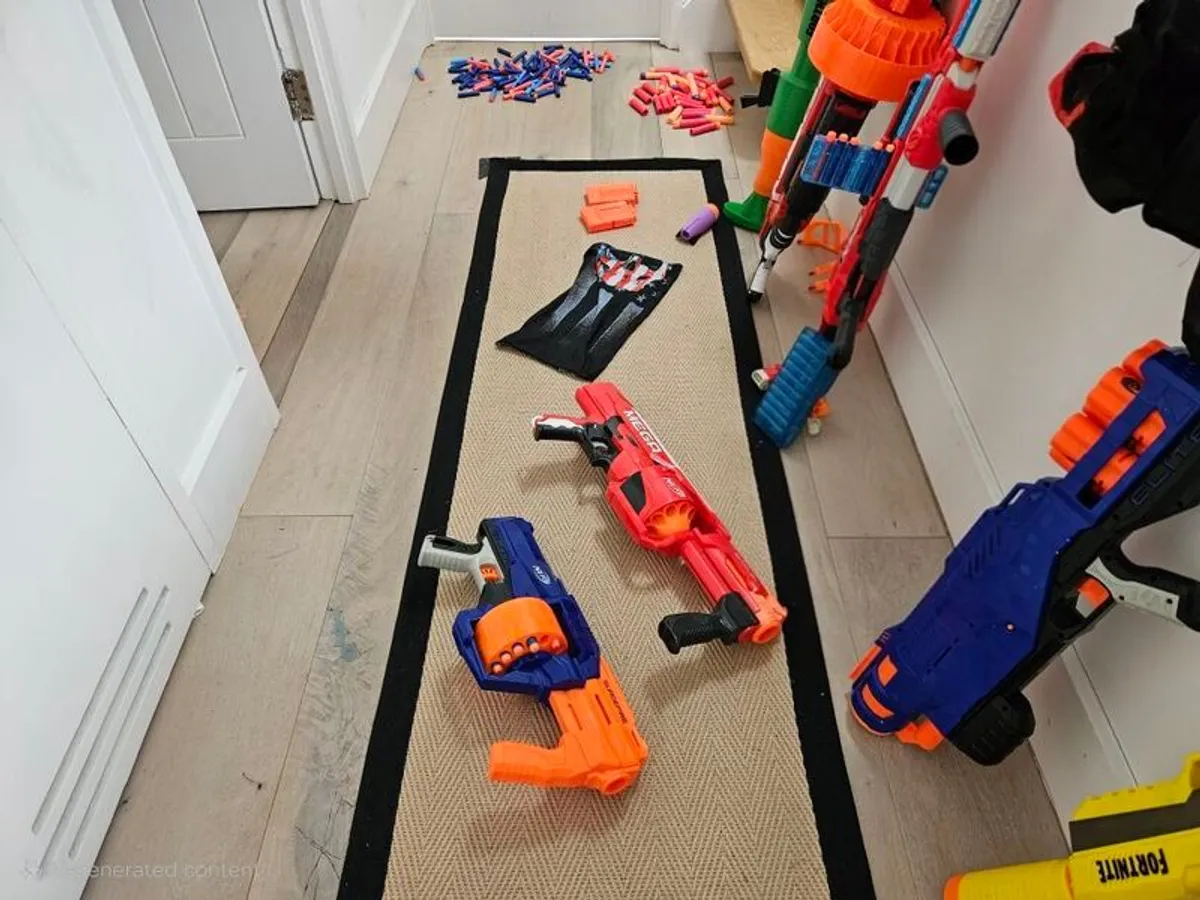 Collection of Nerf Guns, ammunition vests, safety goggles and Fortnite guns. - Image 1