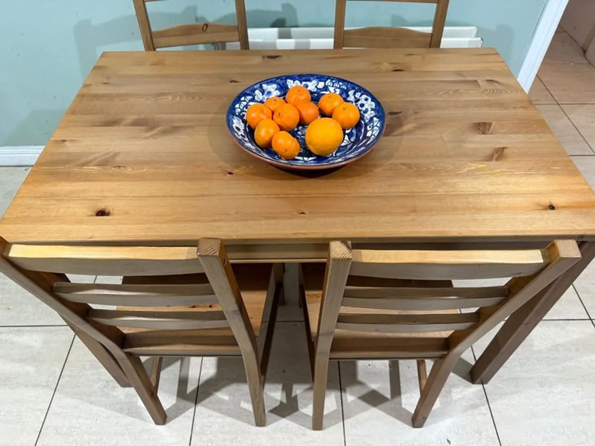 Dark stained pine table and 4 chairs. - Image 1
