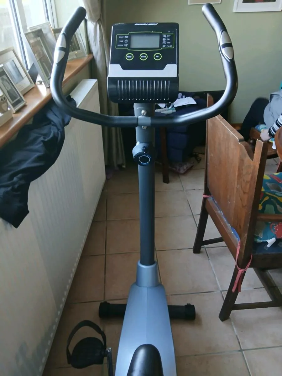 A chair , an exercise bike, and a wheelchair - Image 2