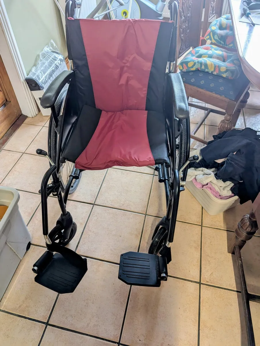 A chair , an exercise bike, and a wheelchair - Image 4