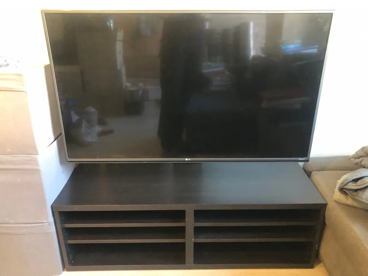 LG UHD 4K TV with TV cabinet and swivel stand - Image 1