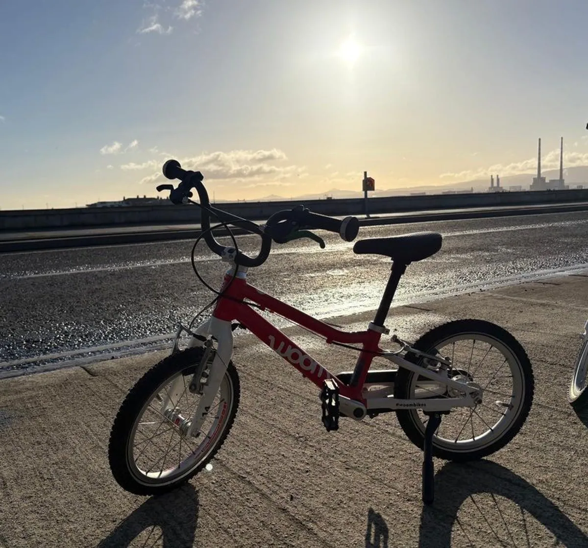 Woom 2 red children's bike with kick stand - Image 1