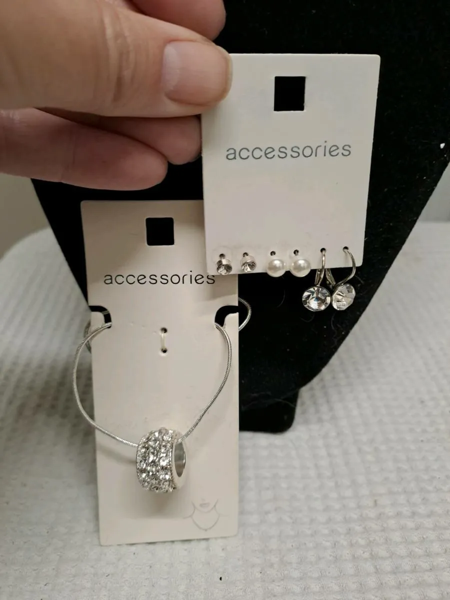 Silver necklace and multiple earrings set - Image 1