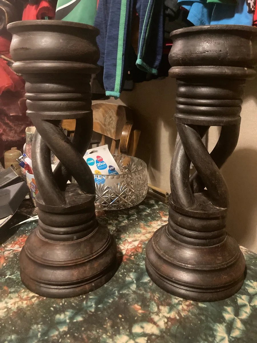 Two large hand craved wooden candle holders