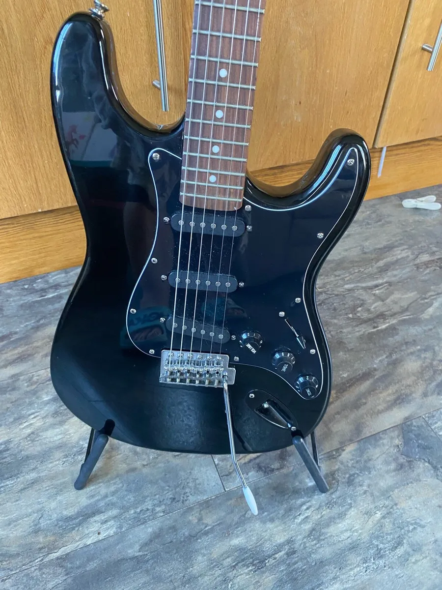 Encore electric guitar with stand and tuner - Image 1