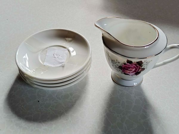 Milk Jug & 4 White Porcelain Saucers (used). - Main image