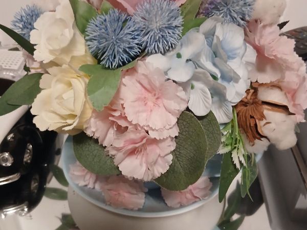 A lovely.flowers  in a cup and saucer. - Main image