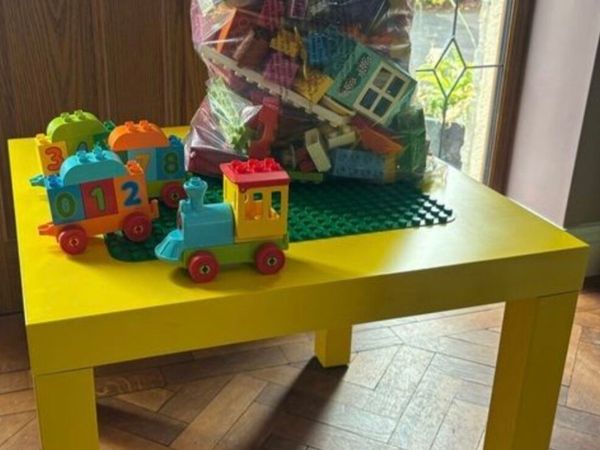 Large bag of duplo,  yellow ikea table. Green d - Main image