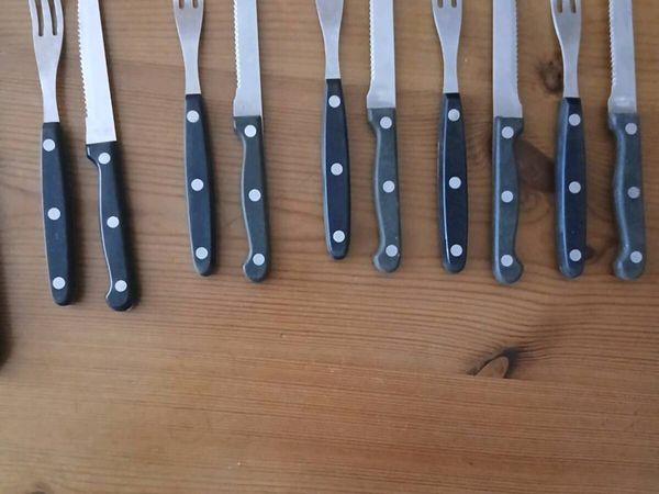 A 12-piece stainless steel steak knife and fork se - Main image