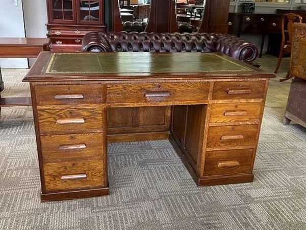 Substantial traditional oak desk with a green tool - Main image