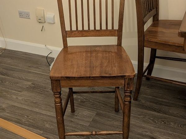 Wooden dining table with tiled top and matching chairs - Main image