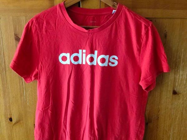 red Adidas t-shirt features a prominent white logo - Main image
