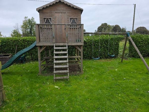 Wooden playhouse with slide and swings - Main image