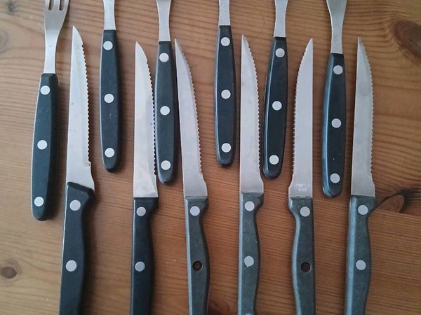 A 12-piece stainless steel steak knife fork set. - Main image
