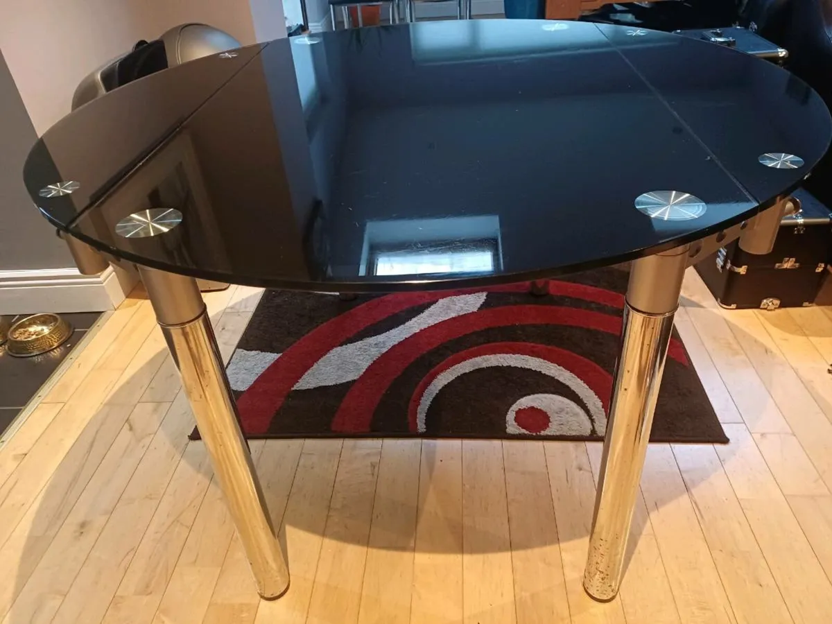 Extendable black glass kitchen table and chairs - Image 1