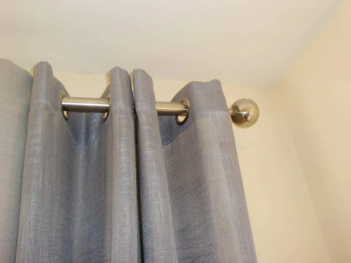 TWO panels of grey eyelet curtains W132cm x H226cm - Image 1