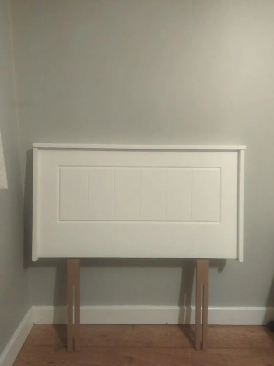 Two white single headboards