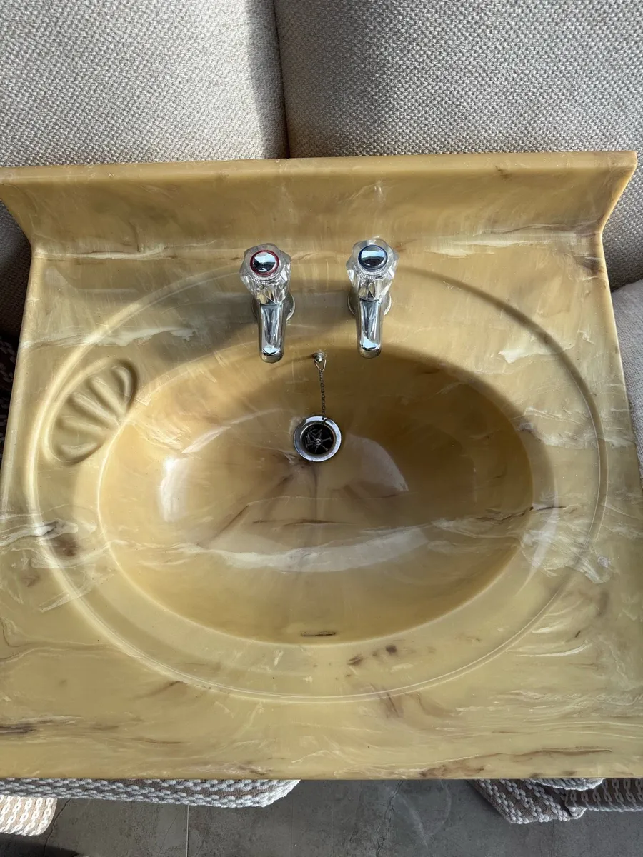 Beige swirled marble pattern sink with taps - Image 1