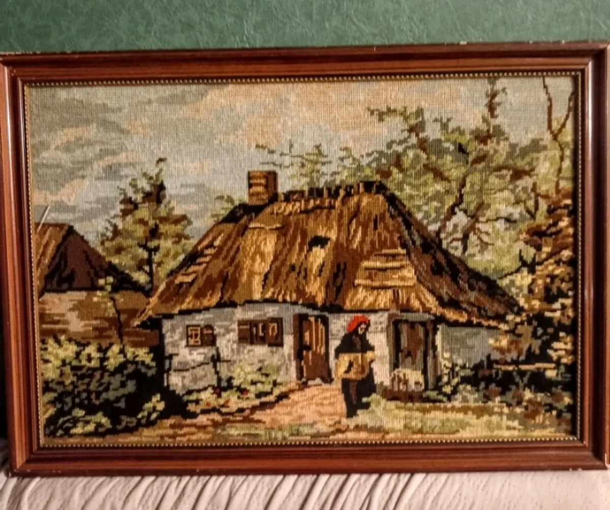 Framed tapestry with thatched cottage