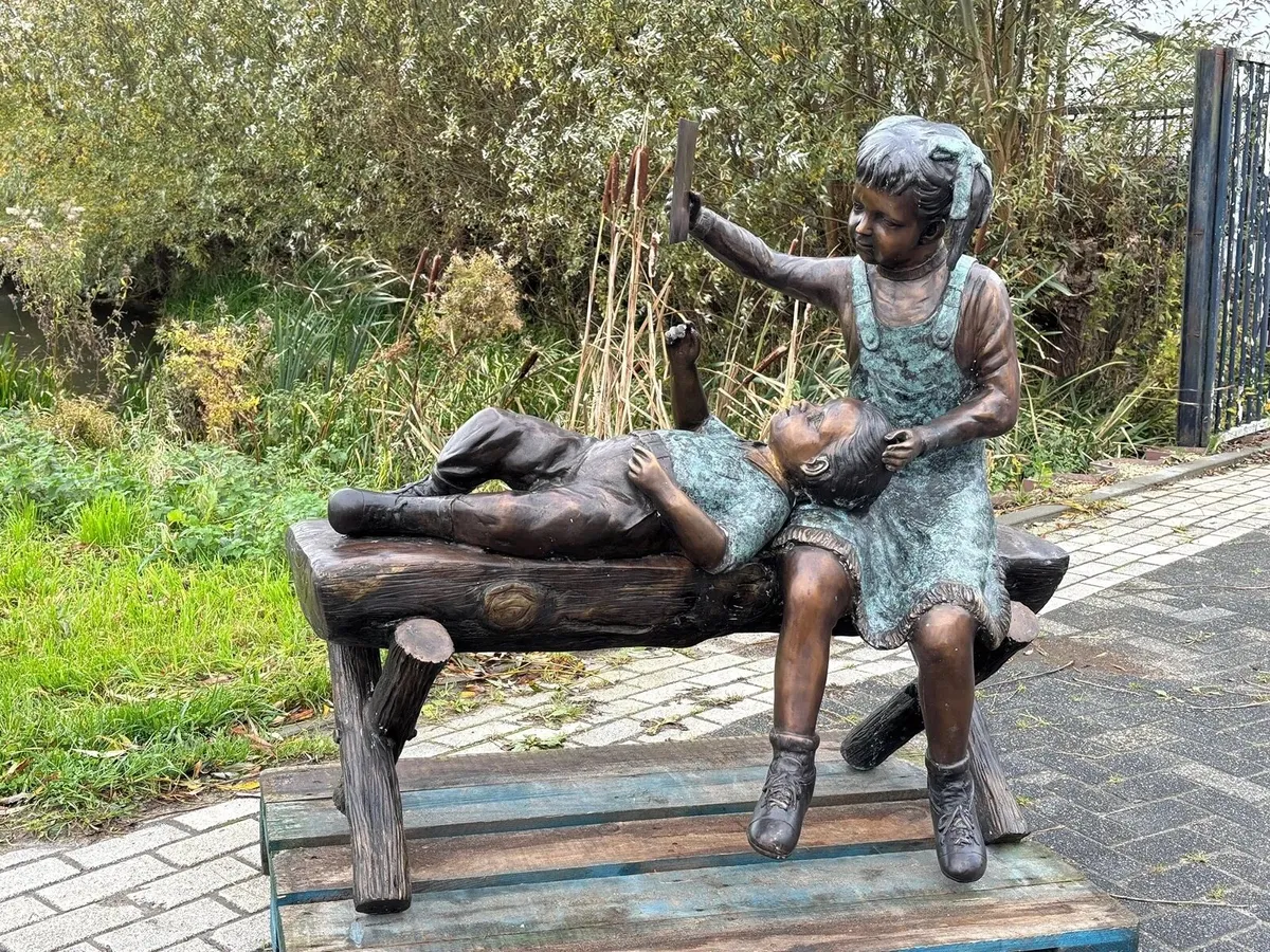 Bronze boy and girl on log bench - Image 4