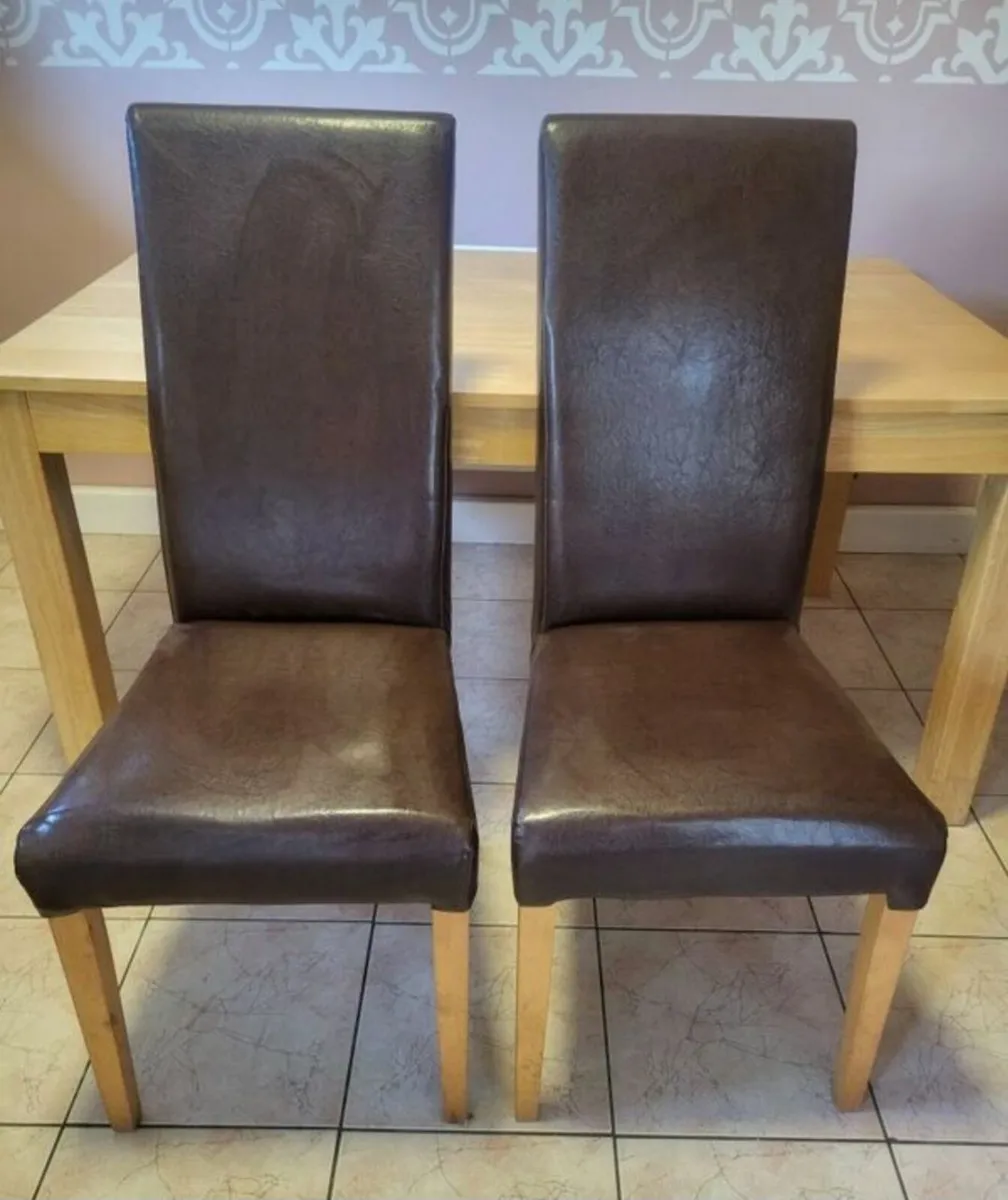 2 brown leather chairs