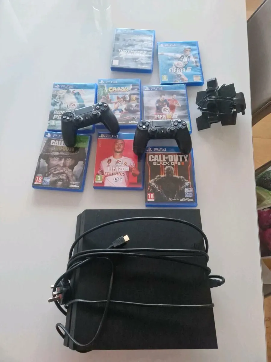 PS4 with 8games + 2 controllers + charging station - Image 1