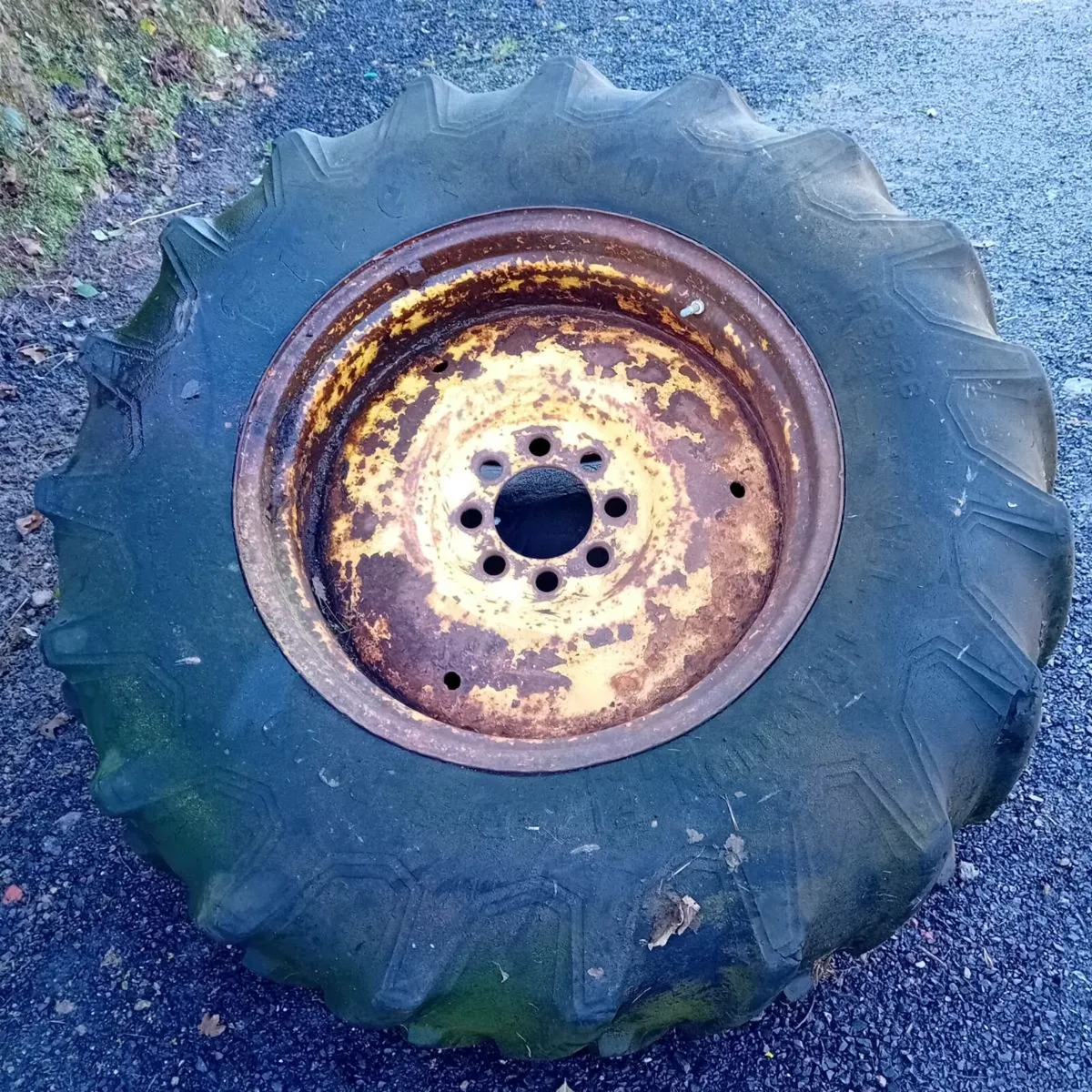 One  16.9x28  tire and rim and concrete weight - Image 2