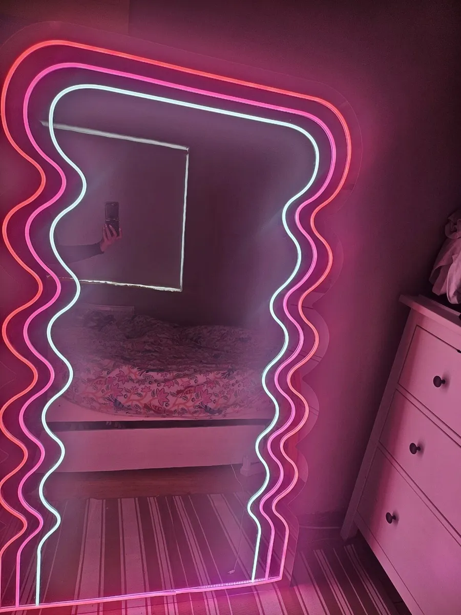Pink and white neon wave mirror.