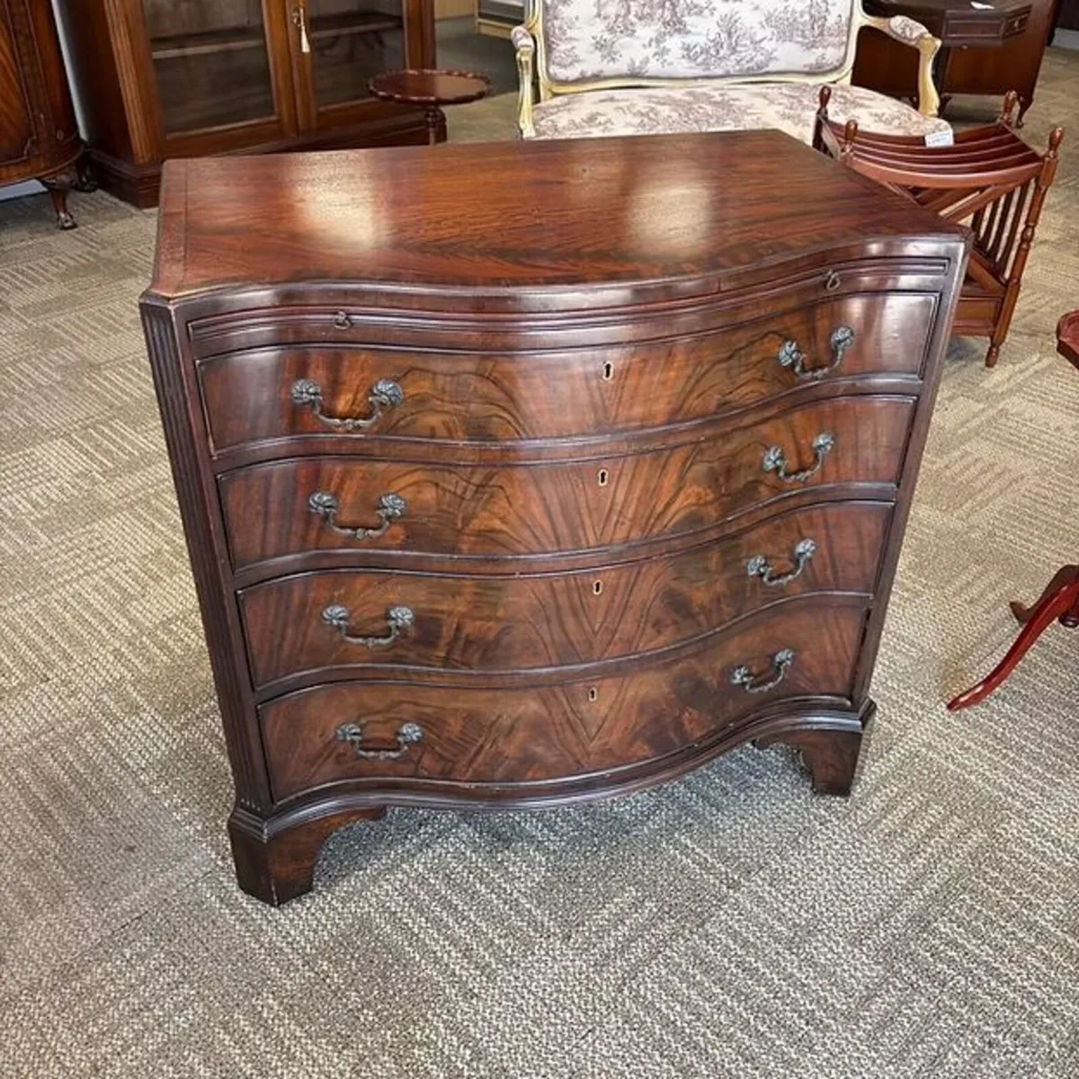 Bevan Funnell mahogany flamed serpentine chest of