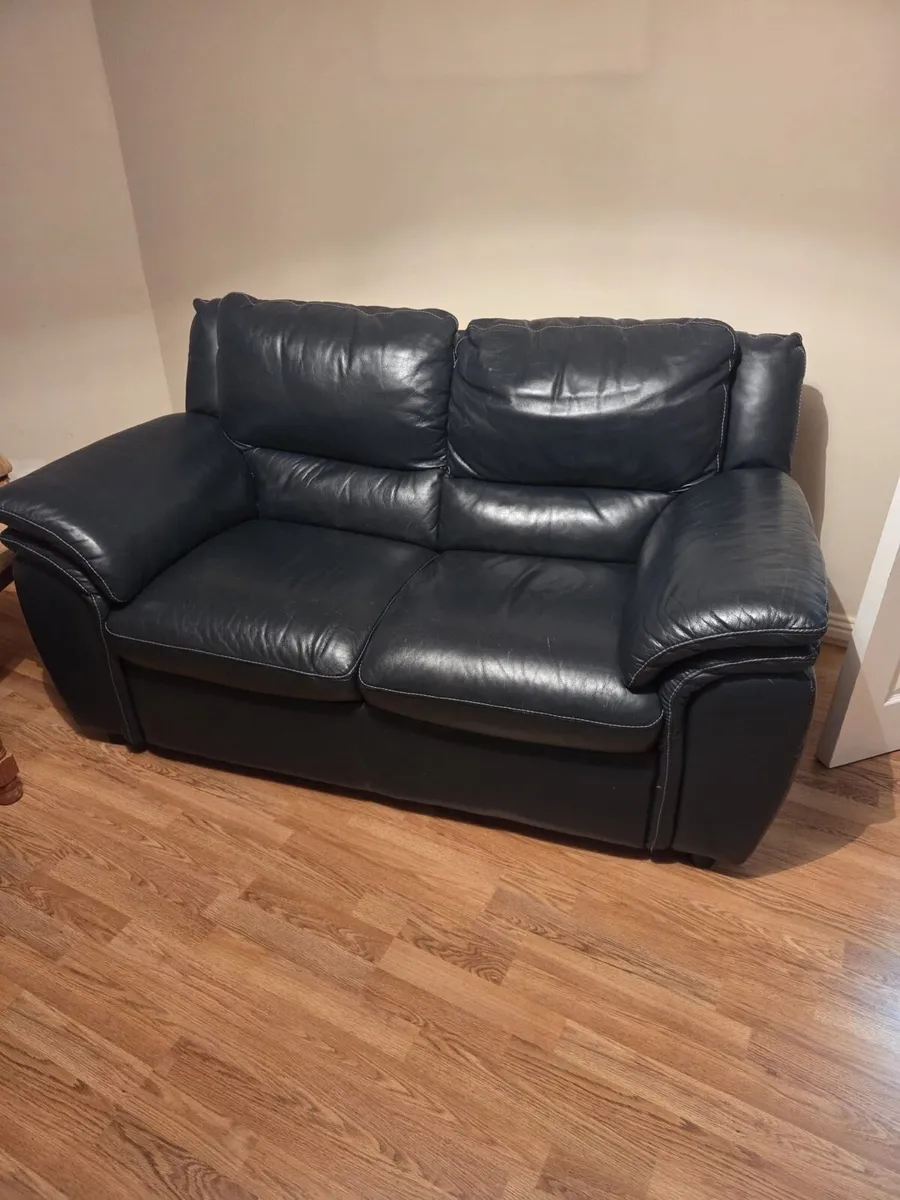 Black leather two seater couch