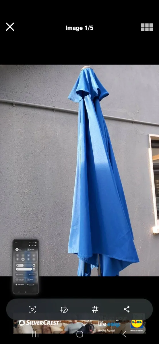 Blue parasol and concrete base - Image 1