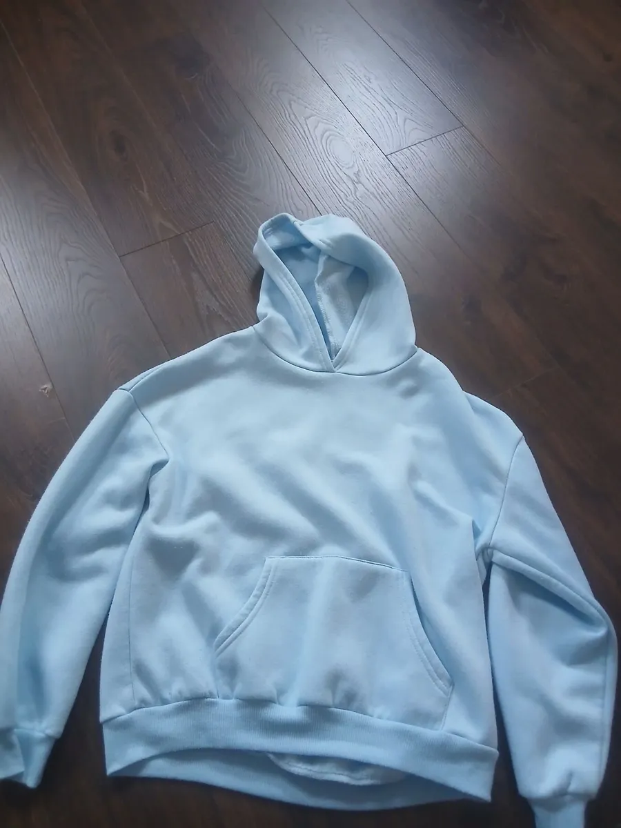 Blue jumper/sweater with decal on its back - Image 1