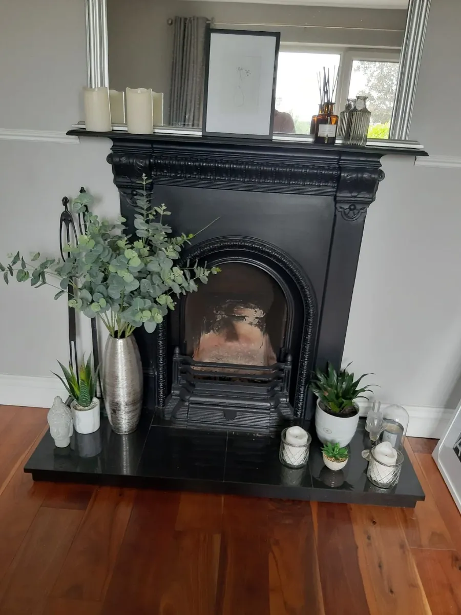 Black cast iron  fireplace with  granite base.