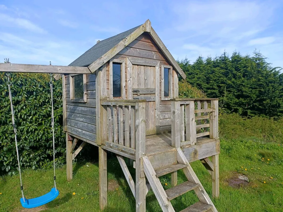 Timber playhouse and swings - Image 1