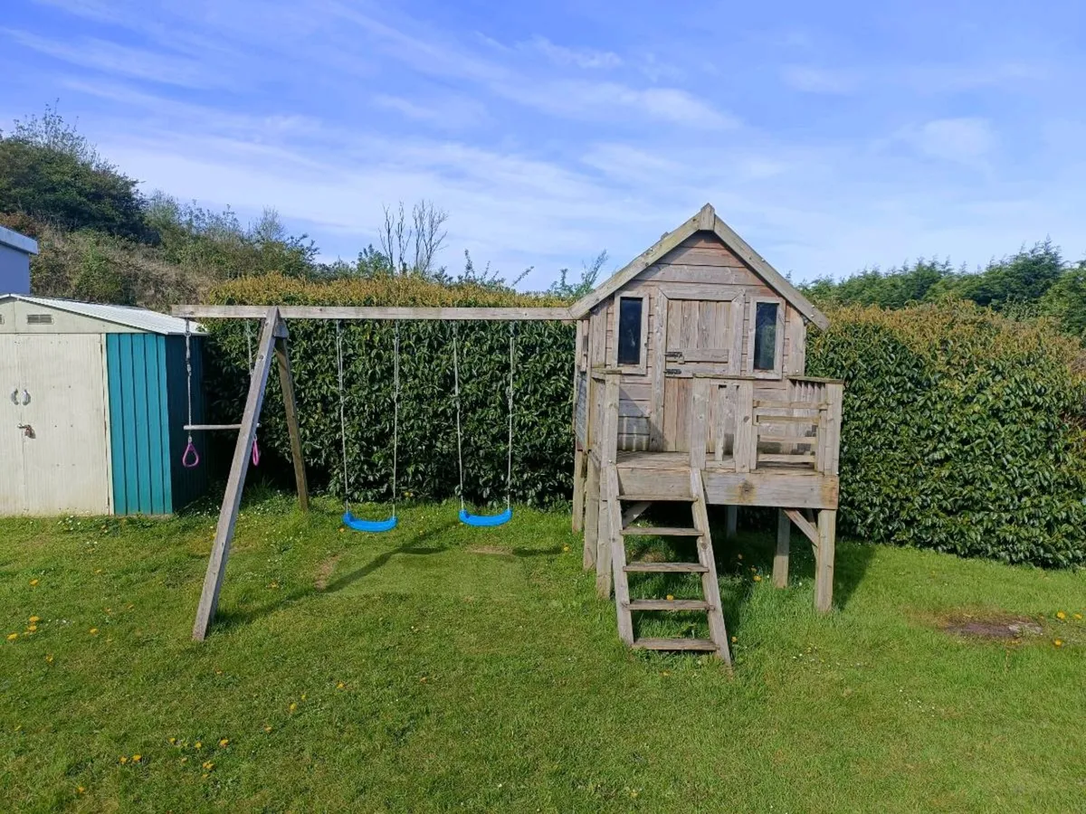 Timber playhouse and swings - Image 3
