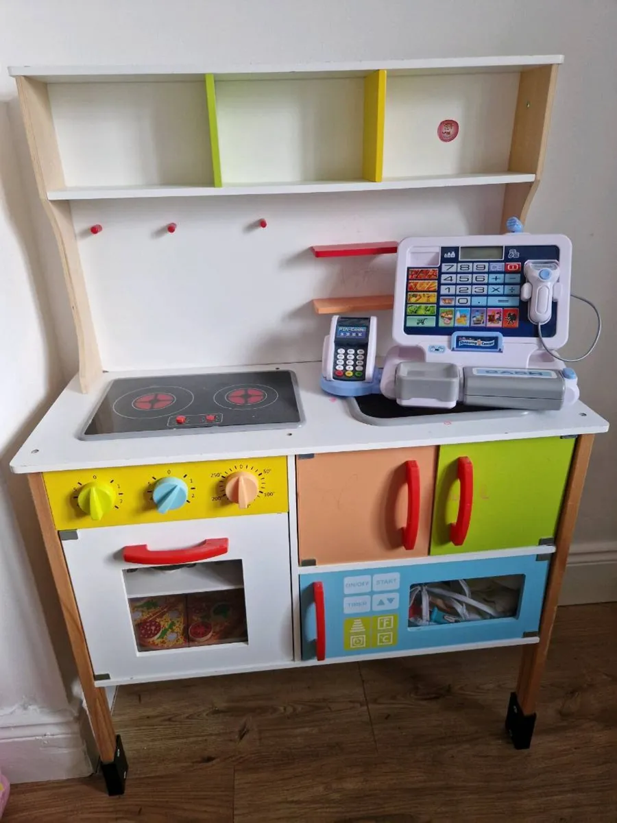 Kid's kitchen with utensils and cash register