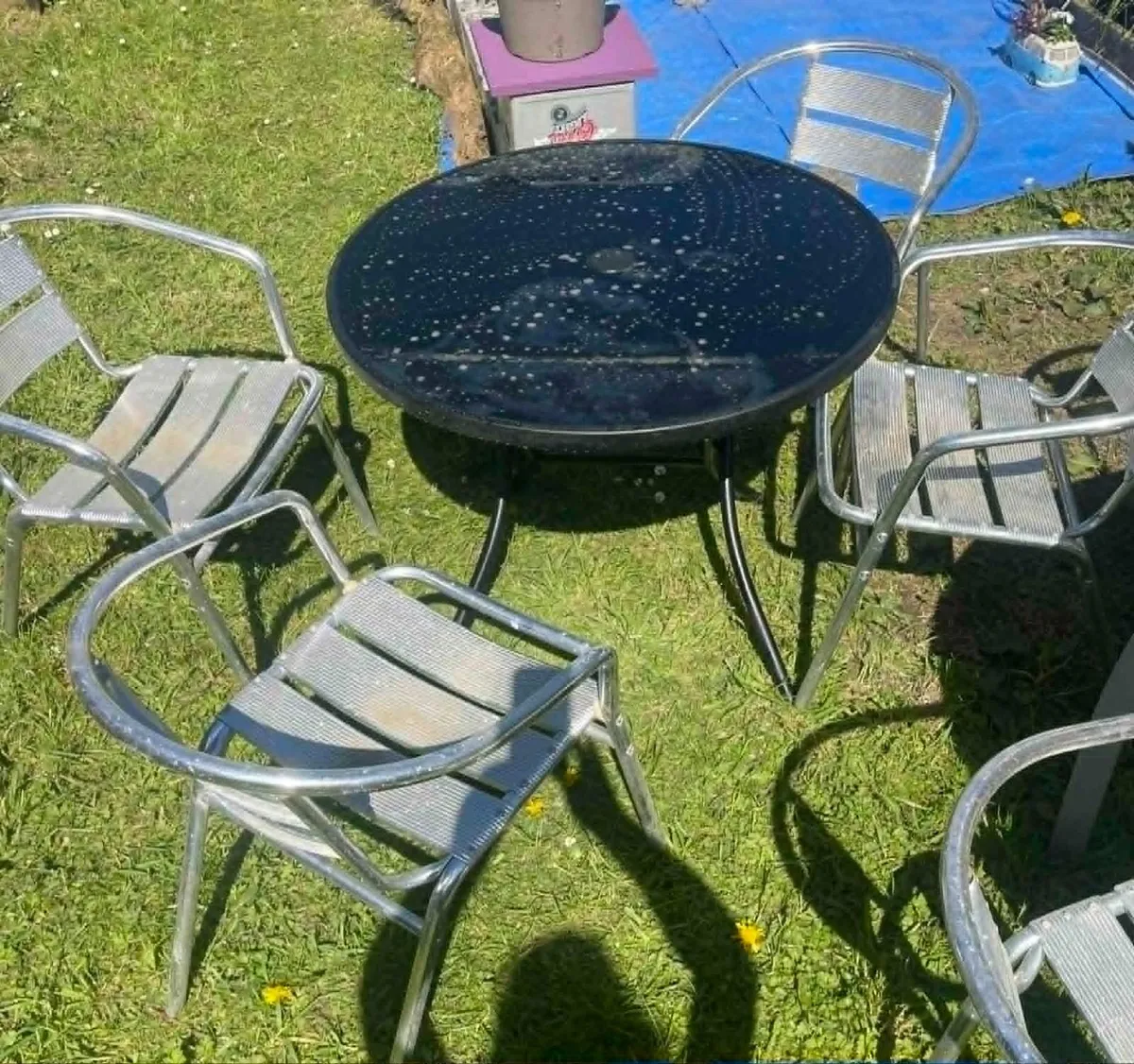 glass garden table (folds) and 4  stackable chairs