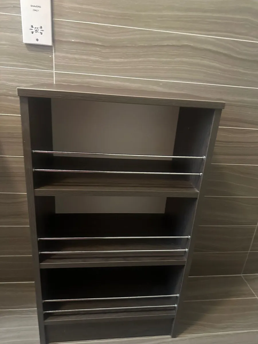 Dark wood storage unit with metal rails - Image 1