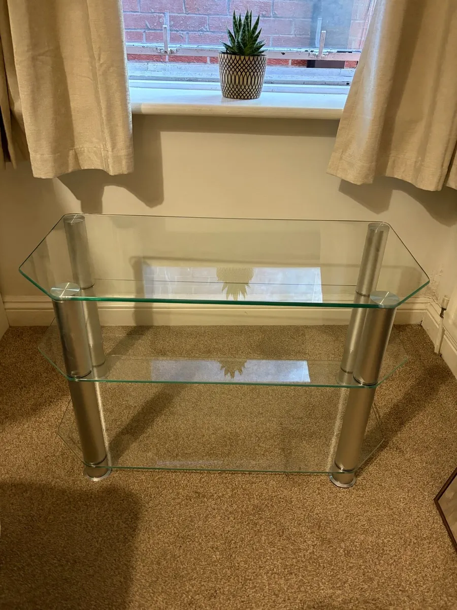 Glass TV stand with chrome legs - Image 1
