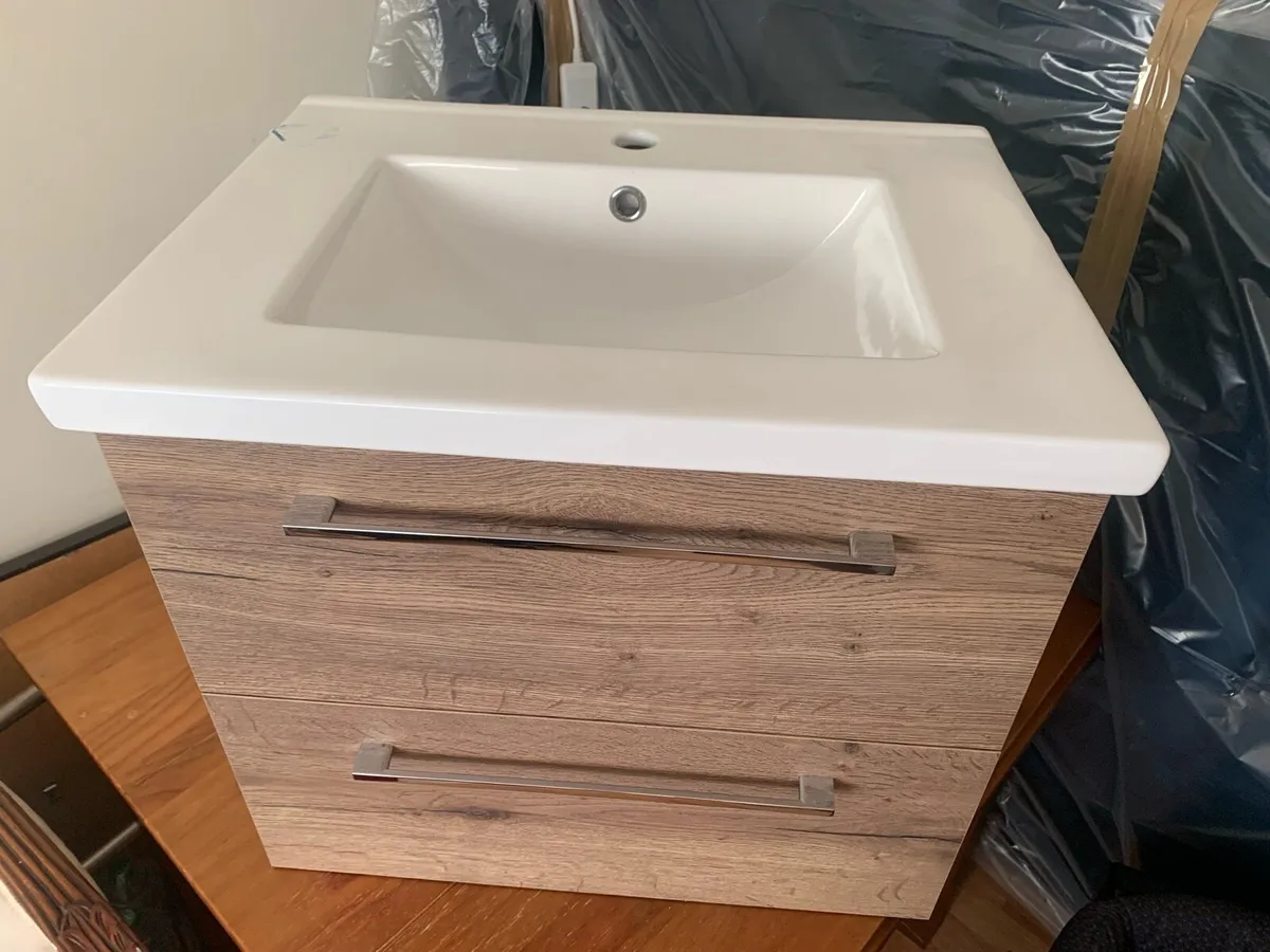 Floating dark wood sink cabinet - Image 1