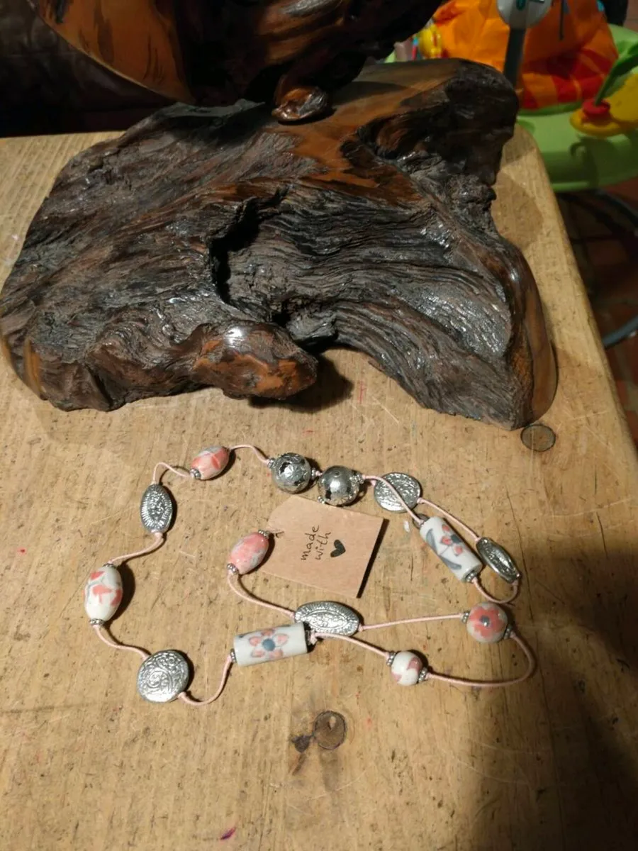 This handmade necklace features a combination of c - Image 2